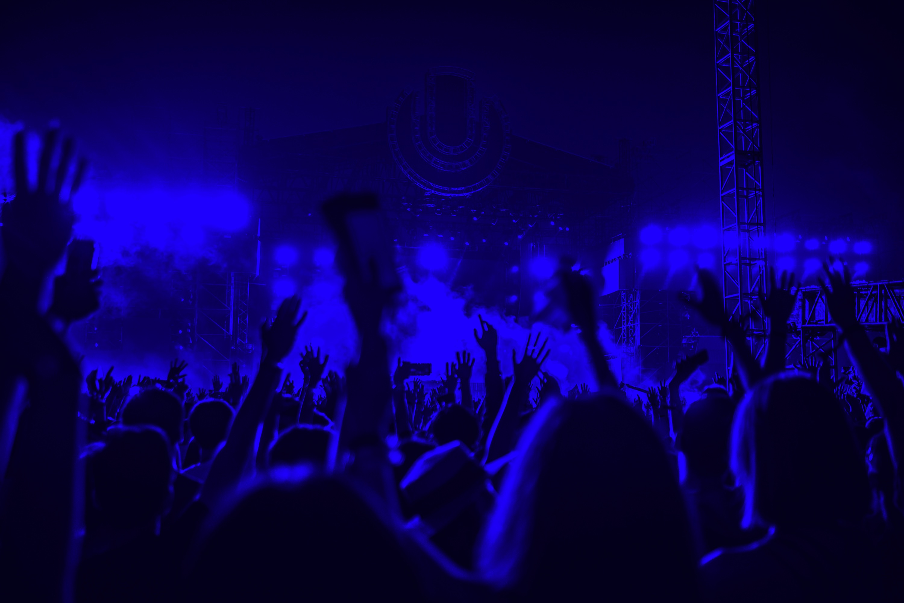 Concert crowd with blue stage lighting
